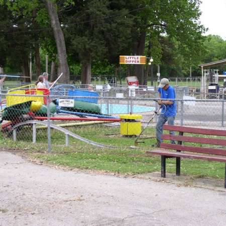 Volunteers clean up Kiddie Park to prepare it for opening weekend.