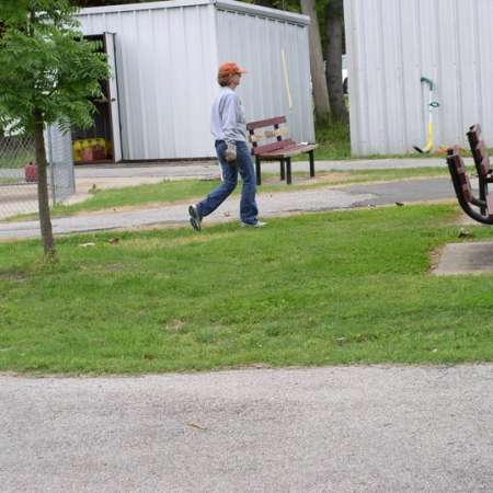 Volunteers clean up Kiddie Park to prepare it for opening weekend.