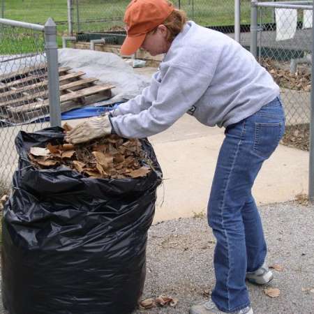 Volunteers clean up Kiddie Park to prepare it for opening weekend.