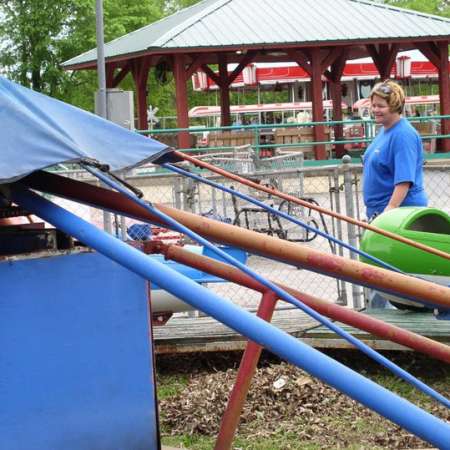 Volunteers clean up Kiddie Park to prepare it for opening weekend.