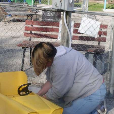 Volunteers clean up Kiddie Park to prepare it for opening weekend.