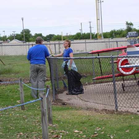 Volunteers clean up Kiddie Park to prepare it for opening weekend.