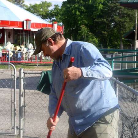 Volunteers clean up Kiddie Park to prepare it for opening weekend.