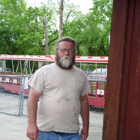 Volunteers clean up Kiddie Park to prepare it for opening weekend.