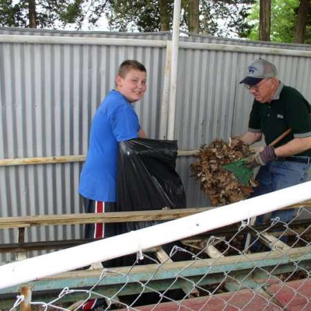 Volunteers clean up Kiddie Park to prepare it for opening weekend.