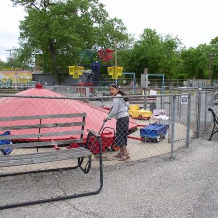 Volunteers clean up Kiddie Park to prepare it for opening weekend.