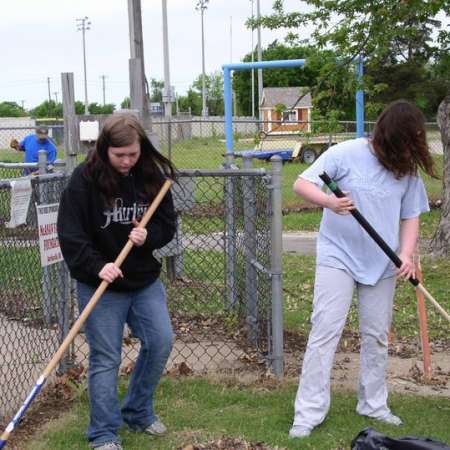 Volunteers clean up Kiddie Park to prepare it for opening weekend.