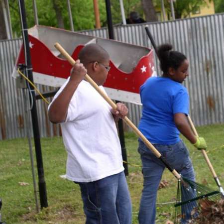 Volunteers clean up Kiddie Park to prepare it for opening weekend.