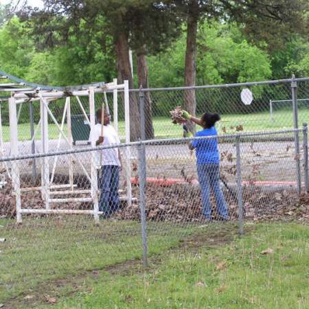 Volunteers clean up Kiddie Park to prepare it for opening weekend.