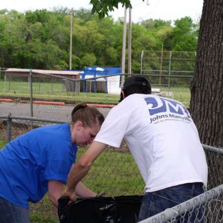 Volunteers clean up Kiddie Park to prepare it for opening weekend.