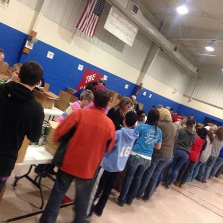 Volunteers waiting to fill their boxes.