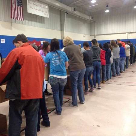 Volunteers waiting to fill their boxes.