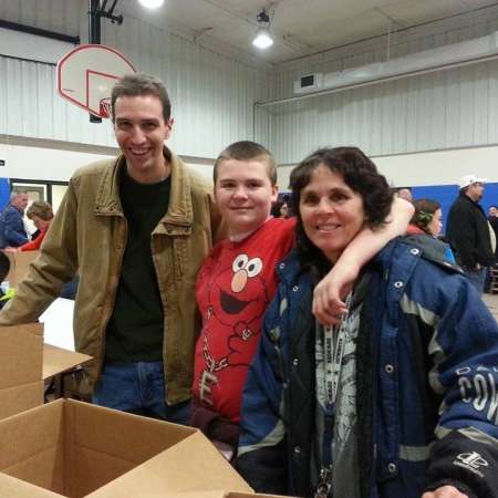 Stephen, Jacob, and Brenda help pack boxes.