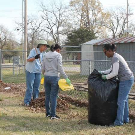 Volunteers clean up Kiddie Park for opening weekend.