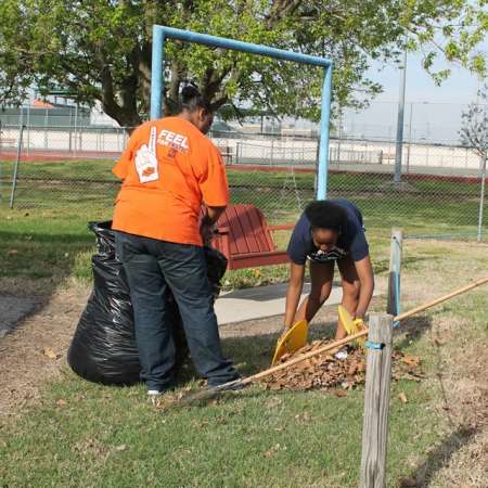 Volunteers clean up Kiddie Park for opening weekend.