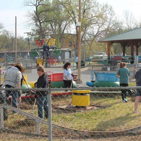 Volunteers clean up Kiddie Park for opening weekend.