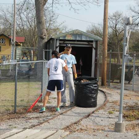 Volunteers clean up Kiddie Park for opening weekend.