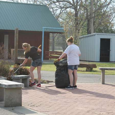 Volunteers clean up Kiddie Park for opening weekend.