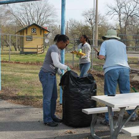 Volunteers clean up Kiddie Park for opening weekend.