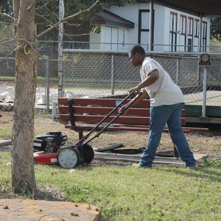 Volunteers clean up Kiddie Park for opening weekend.