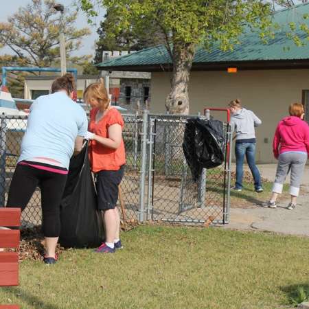 Volunteers clean up Kiddie Park for opening weekend.