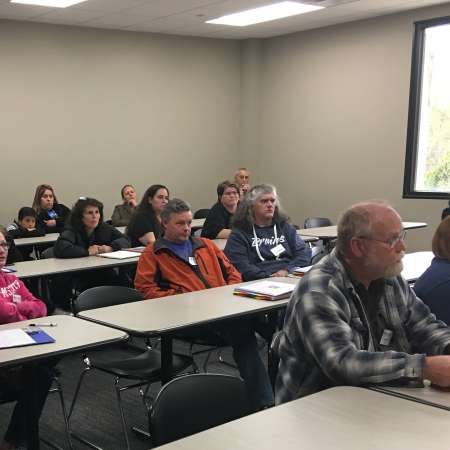 Parents review College Prep Binder at April QM.