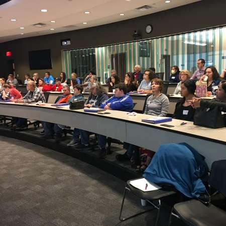 Group listens to Meet the Mentor segment at April QM.