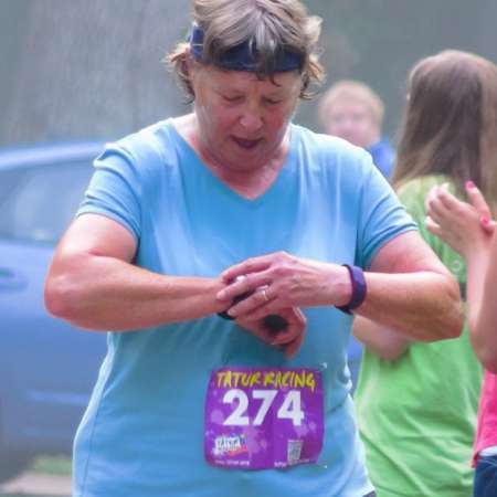 Runner checks her time after the race.