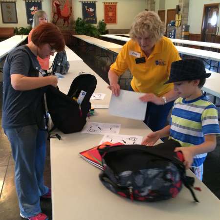 Randy checks the items in her backpack.