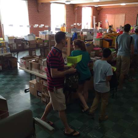 Volunteers pack bags.