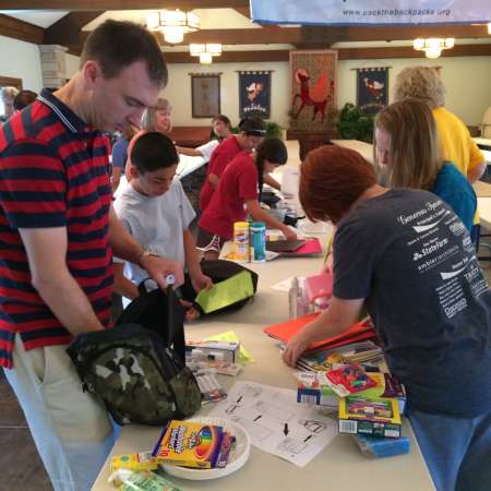 LFYS Volunteers work on stuffing backpacks.