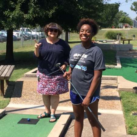 Kandace and her mentor Virginia enjoy the mini golf event.