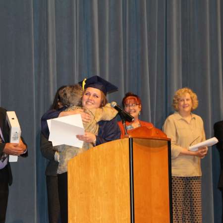 Katy receives her scholarship from Mentor Joan.