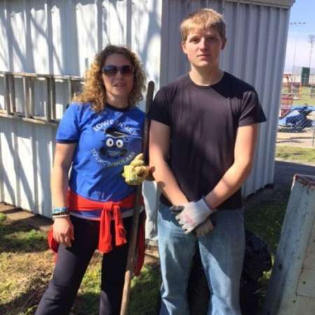 Students, parents, and mentors clean up Kiddie Park before opening.