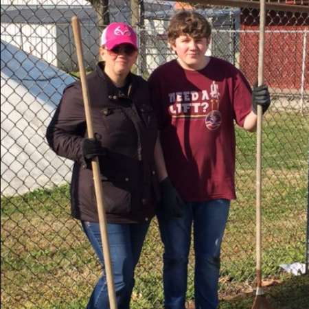 Students, parents, and mentors clean up Kiddie Park before opening.