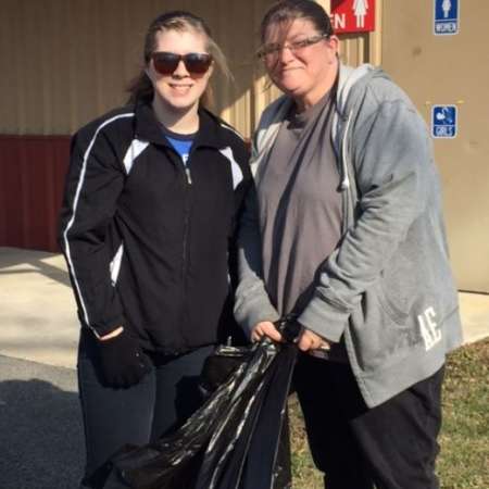 Students, parents, and mentors clean up Kiddie Park before opening.