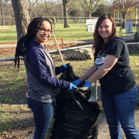 Students, parents, and mentors clean up Kiddie Park before opening.