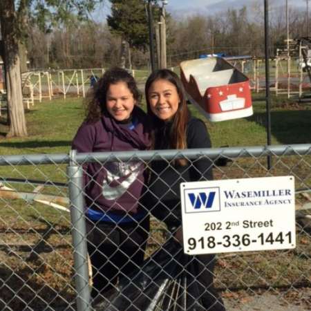 Students, parents, and mentors clean up Kiddie Park before opening.