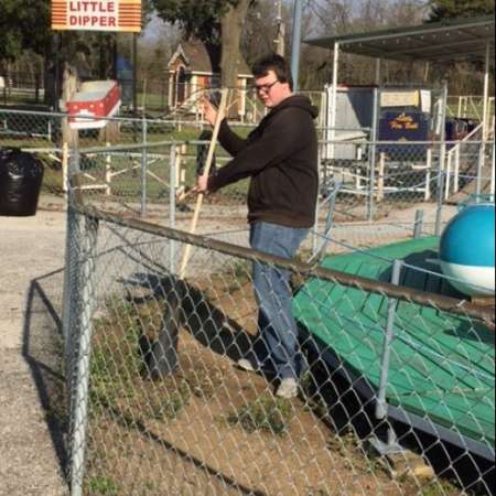 Students, parents, and mentors clean up Kiddie Park before opening.