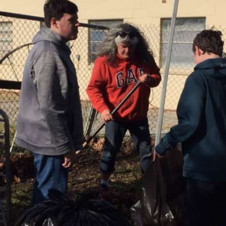 Students, parents, and mentors clean up Kiddie Park before opening.