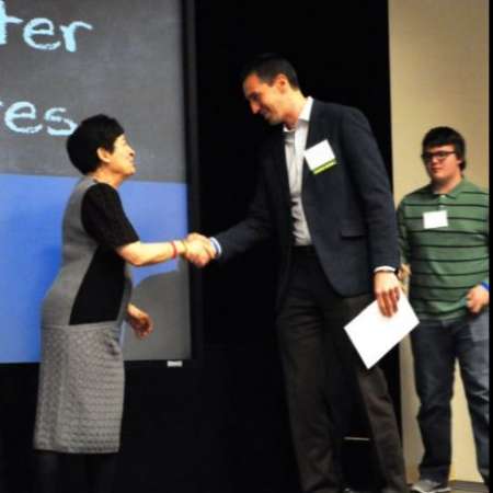 Stephen M. accepts award.